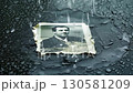 Old photo getting wet on dark surface 130581209