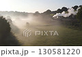 Black steam train moving on railway in misty morning countryside 130581220