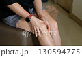 Asian woman hand holding knee in pain symbolizing joint injury arthritis or muscle strain 130594775