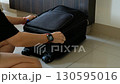 packing luggage with woman hands folding clothes for journey tourism or business travel 130595016