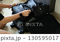 packing luggage with woman hands folding clothes for journey tourism or business travel 130595017