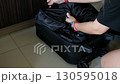 packing luggage with woman hands folding clothes for journey tourism or business travel 130595018