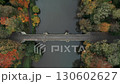 Static drone shot looking directly down on Prebends Bridge, Durham, England at the height of Autumn with people crossing 130602627