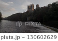 Drone flies slowly and rises over the weir on the River Wear towards Durham Cathedral. Shot in mid autumn 130602629