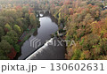 Drone flies slowly over weir in Durham, England towards Prebends Bridge. Shot on a beautiful autumn day 130602631