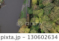 Drone flies slowly over weir on River Wear  in Durham, England looking directly down on weir and Old Corn Mill. Shot on a beautiful autumn day.  130602634