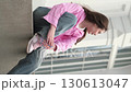 Girl with flowing hair enjoys a carefree moment while sitting outdoors. The dynamic live shooting highlights spontaneity, individuality, and the beauty of genuine emotions in everyday life. 130613047