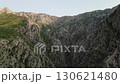 Sunlit ridge and jagged canyon wall in remote Uzbekistan mountain range 130621480