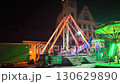 A popular attraction known as a pirate ship and a fairground merry go round. A pirate ship as a carnival attraction. A traditional pirate ship as a swing ride. Illuminated pirate ship swing boat ride 130629890