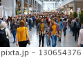 Crowd in busy convention center, possibly a trade show or exhibition. Lively atmosphere suggests a bustling market and thriving business. 130654376