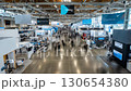 A time-lapse of people moving between exhibition stands, capturing the buzz of a busy conference and trade show event. 130654380