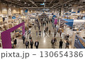 Busy art fair from above: People browse exhibits and artwork. A vibrant scene of creativity and commerce. 130654386