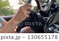 Man driving car. hand on the steering wheel against the background of the road on sunny day 130655178
