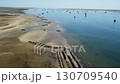 Ria Formosa riverbed with shellfish production and yachts anchored in the river Ria Formosa riverbed with shellfish production and yachts anchored in the river 130709540