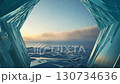 A tranquil panoramic view of the ice fields at dawn and the pale morning sky seen from an ice cave 130734636