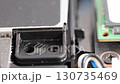 close up. screwdriver and screw. A technician disassembles a laptop. 130735469