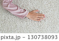 a woman's hand touching the beige Interior pile carpet made of polypropylene.  130738093