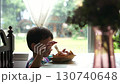 Thai Toddler Having Salt Bread Next to the Window 130740648