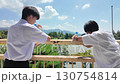 校庭を眺める男子中学生と友達　学校生活 130754814
