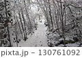 Video of walking on a narrow path through a snowy forest. Winter adventure and exploration. 130761092