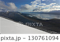 Panoramic view of the strait from the snowy slopes of a mountain. A powerful backdrop for nature and adventure. 130761094
