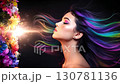 A video of a model with rainbow-colored hair, smelling flower scents, with fantastic effects of explosive light. 130781136