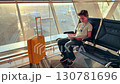 Teenager reading a book in Baku Airport during golden hour 130781696
