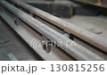 Shiny new bolts sparkle on dusty rails under dim light 130815256