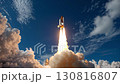 Rocket launch sequence showcasing powerful ascent through clouds with vibrant flames and smoke, capturing the dynamic energy of space exploration and technological advancement 130816807
