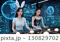 Two playful women wearing black and white bunny ears operate a glowing console together in a futuristic cyberpunk style data analysis center. Two playful women wearing black and white bunny ears operate a glowing console together in a futuristic cyberpunk style data analysis center. 130829702