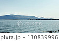 Seascape, view of huge white tanks, oil and fuel storage facilities, mountains on the horizon, industrial Iceland landscape. 130839996