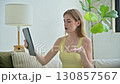 Young woman using digital tablet for video call, online chat conference sitting at home 130857567