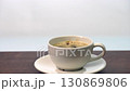 Adding coffee with 3 organic sugar cubes in ceramic cup hot beverage on wooden table, minimal style 130869806