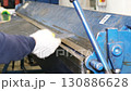 Metal worker bending sheet metal with bending machine 130886628