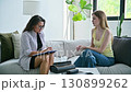 Young woman at therapy session with female psychologist, social worker 130899262
