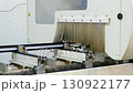 Automated machinery processing metal profiles in factory setting 130922177