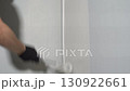 Men's hands paint the walls with a roller, paint on the surface, paint the walls in the apartment. High quality 4k footage 130922661