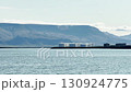 Seascape and industrial, horizon view of huge white tanks, oil and fuel storage facilities, mountain on the horizon, industrial Iceland landscape. 130924775