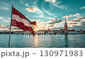 Majestic flag waves amidst vibrant sunset over serene waterfront cityscape. Latvia Independence Day. Flag of Latvia and view of Riga 130971983