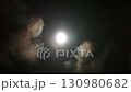 The full moon appears and disappears behind the drifting clouds 130980682