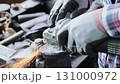 Zoom Back View Construction Industrial Factory or Metalwork Concept by Mechanic or Technician Using Grinder with Auto Part Workshop 131000972