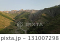 Aerial view of narrow canyon road and green hills in Baysuntau, Boysun, Uzbekist 131007298