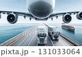 Dynamic Transportation A Challenging Airplane Landing Right Between Trucks on the Busy Highway Roadway 131033064