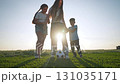 Boy and girl woman stand grass. Family enjoys soccer game together. Outdoor activity creates fun moment. Soccer ball between feet. Playing with ball builds sport skills. Family plays soccer on grass 131035171
