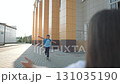 Happy student with backpack runs toward mother after school. Boy running to woman with open arms. Kid smiles returning. Running child ready for hugging. Boy returns happy. Student rushes to mother. 131035190