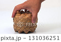 Open the basket made from palm leaves and take out the sticky rice by hand, shape it into a ball and close it on white. 131036251