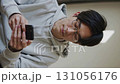 Vertical loop video of a young man's everyday life using a smartphone 131056176