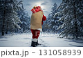 Santa walking through snow, carrying a bag full of presents, christmas spirit concept footage 131058939