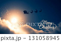 Santa Claus sleight and reindeer silhouette flying showing merry christmas message in the night and clouds 131058945