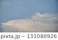 White contrail from a jet plane flying high in the blue sky 131080926